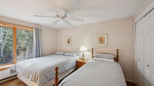 two beds in a room with a window at Quick Silver - Summit at Gore Mountain by AvantStay in North Creek +39 photos