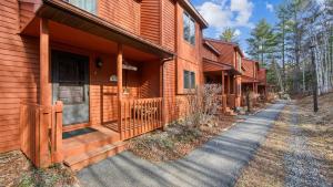 a house with a porch and a walkway in front at Quick Silver - Summit at Gore Mountain by AvantStay in North Creek