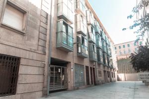 a building with a bunch of windows on a street at Golden Vedra Residences in Pontevedra
