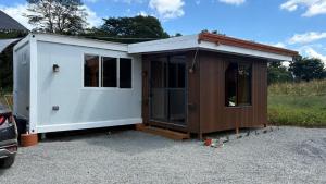 a small white and brown house with a garage at Leha's Apartaments in Buenos Aires