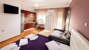 a living room with a couch and a kitchen at Amaya Pine Studio in Panagia