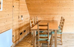 a wooden dining room with a table and chairs at 2 Bedroom Nice Home In Bad Lobenstein in Bad Lobenstein