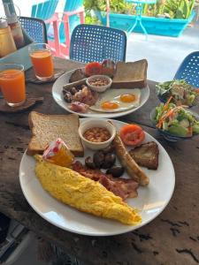 two plates of breakfast food on a wooden table at The Boathouse in Bang Sare