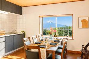a dining room with a table with a view of a mountain at Fuji Nest Izu in Izunokuni