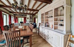 a dining room with a wooden table and chairs at Le Petit Verger in Waimes