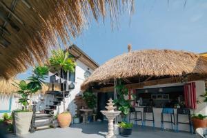 a resort with a thatched roof and a bar at The Boathouse in Bang Sare +47 photos