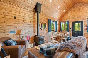 a living room with a couch and a stove at River Retreat Kananaskis in Turner Valley