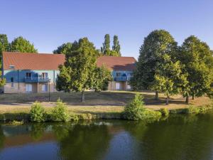 a house next to a river with a building at ibis Styles Bourbon Lancy in Bourbon-Lancy