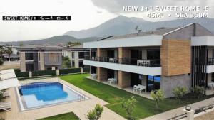 a rendering of a house with a swimming pool at Camyuva Beach Hotel in Kemer