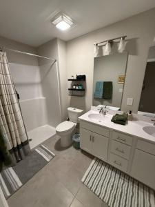 a bathroom with a sink and a toilet and a mirror at Tide's Turn Retreat in Cedar Point