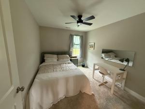 a bedroom with a bed and a ceiling fan at Tide's Turn Retreat in Cedar Point +19 photos