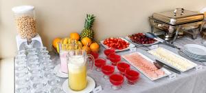 a table with food and drinks and fruit on it at Hotel Premier in Tacna +39 photos