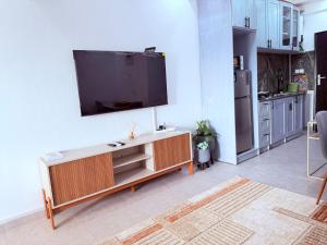 a living room with a flat screen tv on a wall at Julianah appart in Douala