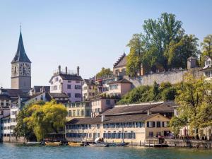 a city with a clock tower and a river at ibis budget Zurich Airport in Glattbrugg
