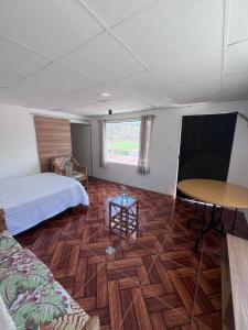 a room with a bed and a table in it at Alojamiento Mujer Dormida in Ambuquí