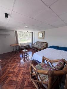 a bedroom with a bed and a table and chairs at Alojamiento Mujer Dormida in Ambuquí