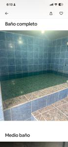 a bathroom with a tub with green water at Alojamiento Mujer Dormida in Ambuquí +20 photos