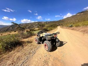 a quad bike parked on a dirt road at Alojamiento Mujer Dormida in Ambuquí
