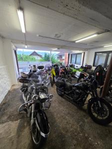 a row of motorcycles parked in a garage at Frühstückspension Irschen in Irschen