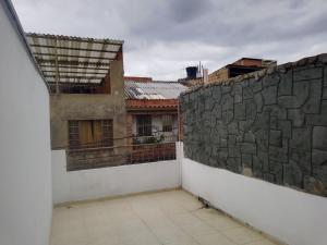 a balcony of a building with a stone wall at hospedaje dorado engativá in Bogotá