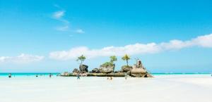 a group of people on a white sandy beach at PNS BORACAY Station 1 in Boracay