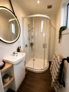 a bathroom with a shower and a sink at Lake Brunner Chalet in Moana