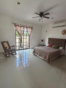 a bedroom with a bed and a ceiling fan at Gated house with garden and pool Mérida in Caucel +28 photos