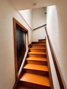 a set of stairs in a building with a window at Lake Brunner Chalet in Moana