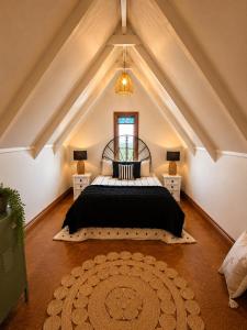 a bedroom with a large bed in the attic at Lake Brunner Chalet in Moana +6 photos