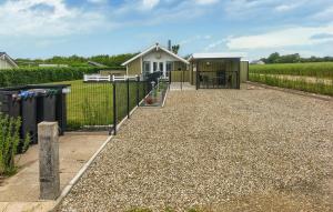 a house with a fence and a gravel driveway at 3 Bedroom Amazing Home In Haderslev in Haderslev