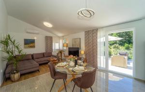 a living room with a table and a couch at Villa Beachfront Korcula in Vela Luka
