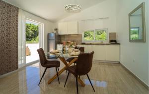 a kitchen and dining room with a table and chairs at Villa Beachfront Korcula in Vela Luka
