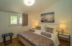 a bedroom with a large bed with two lamps at Villa Beachfront Korcula in Vela Luka