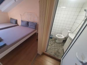 a small room with a bed and a toilet at XAH - HAN Plovdiv Center in Plovdiv +27 photos