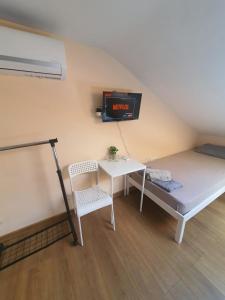 a room with a bed and a table and a clock at XAH - HAN Plovdiv Center in Plovdiv