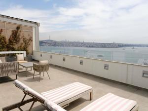 a balcony with chairs and a view of the water at The Artisan Hotel Istanbul - MGallery Collection in Istanbul +177 photos