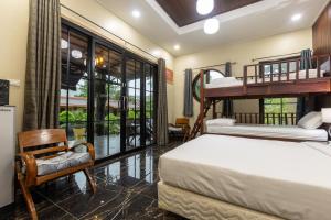 a bedroom with two bunk beds and a balcony at Siray Green Resort in Phuket +155 photos