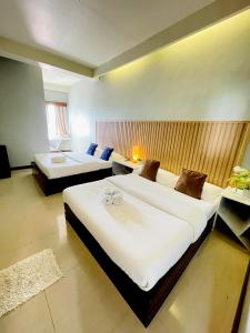 a large bedroom with two beds and a table at Pacific Waves Inn (Annex) in Baler +66 photos