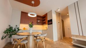 a kitchen and dining room with a wooden table and chairs at Bela Bonita in Spišská Belá