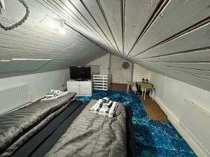a room with two beds and a tv in it at Chic Townhouse - Views Telescope Balcony BBQ in Siglufjörður