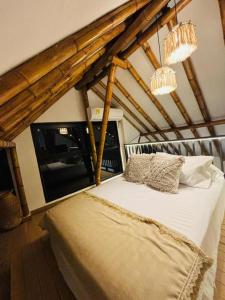 a bedroom with a bed with two pillows on it at FINCA HOTEL GUADUAL Quindío in Quimbaya +63 photos