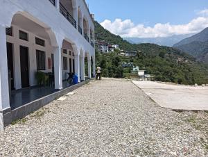 a person standing on the side of a building at Panchkedar resort in Sonprayag