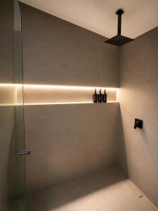 a bathroom with a shower with a glass door at Hotel Laureles Loft in Medellín +35 photos