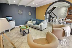 a living room with a couch and chairs and a table at Kerlic in Ploubazlanec