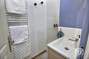 a white bathroom with a sink and a shower at Kerlic in Ploubazlanec +36 photos