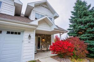 a house with a white garage and a christmas tree at Bluff Haven by Simple Life Rentals in Fish Creek