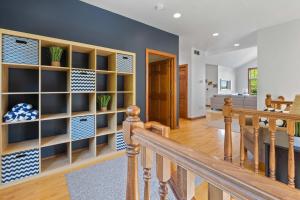 a staircase in a home with blue and white shelves at Bluff Haven by Simple Life Rentals in Fish Creek