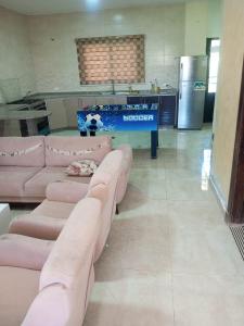 a living room with pink couches and a table at عمان in Az Zarqa