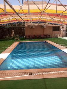 a large swimming pool in a stadium with chairs at عمان in Az Zarqa