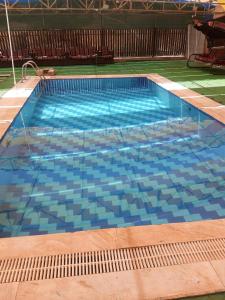 a large swimming pool with blue water at عمان in Az Zarqa +15 photos